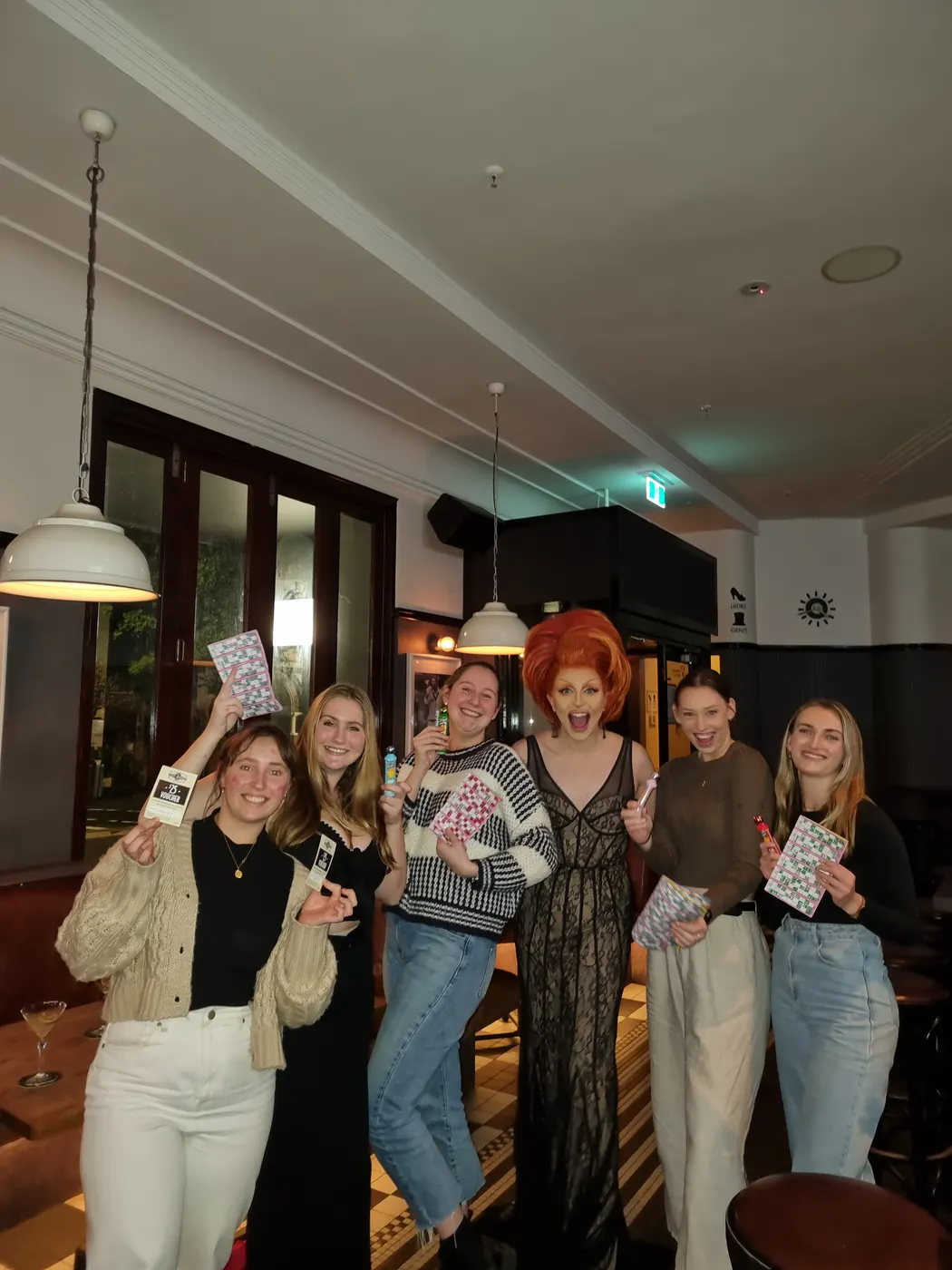 Hens party guests with a Syd Showgirls drag performer at a Sydney pub